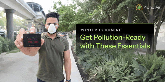 Person wearing an anti-pollution mask and holding an air quality monitor in Delhi’s winter smog