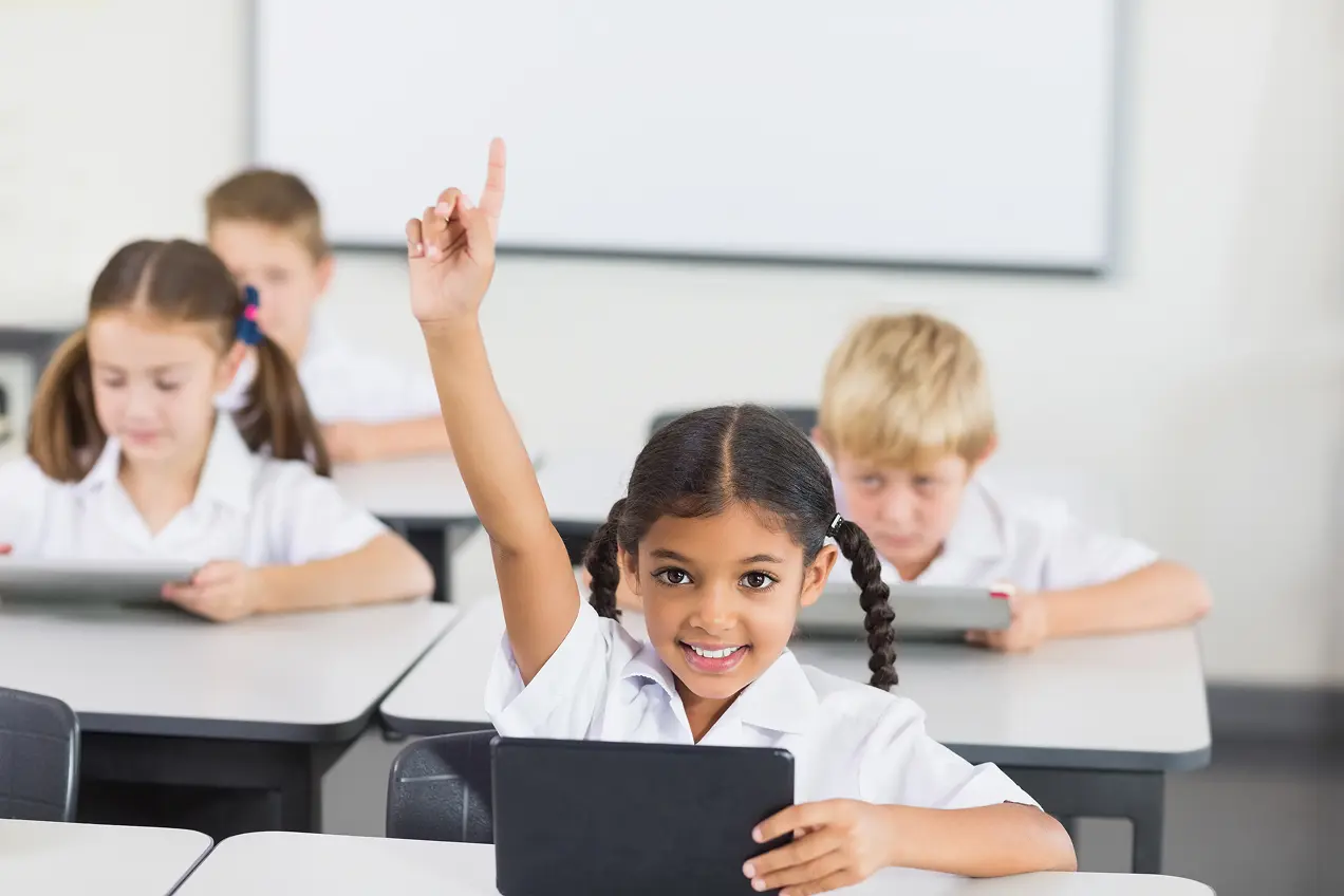 Happy and attentive students in a school classroom